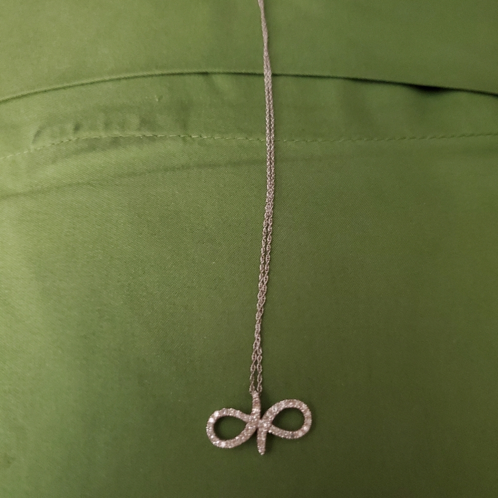 10k white gold and diamond infinity style necklace.